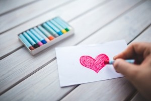 hand-with-oil-pastel-draws-the-heart